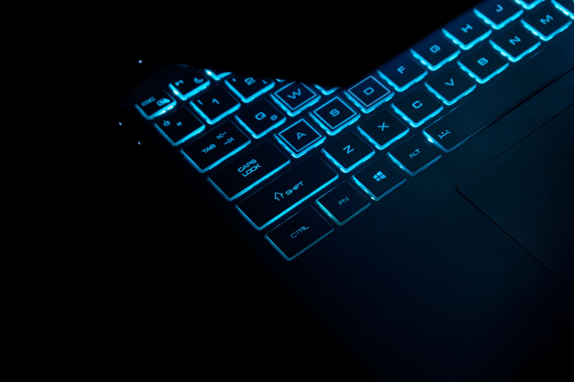 asus rog keyboard not working - Close-up of a glowing laptop keyboard in dark, showcasing illuminated keys and sleek design.
