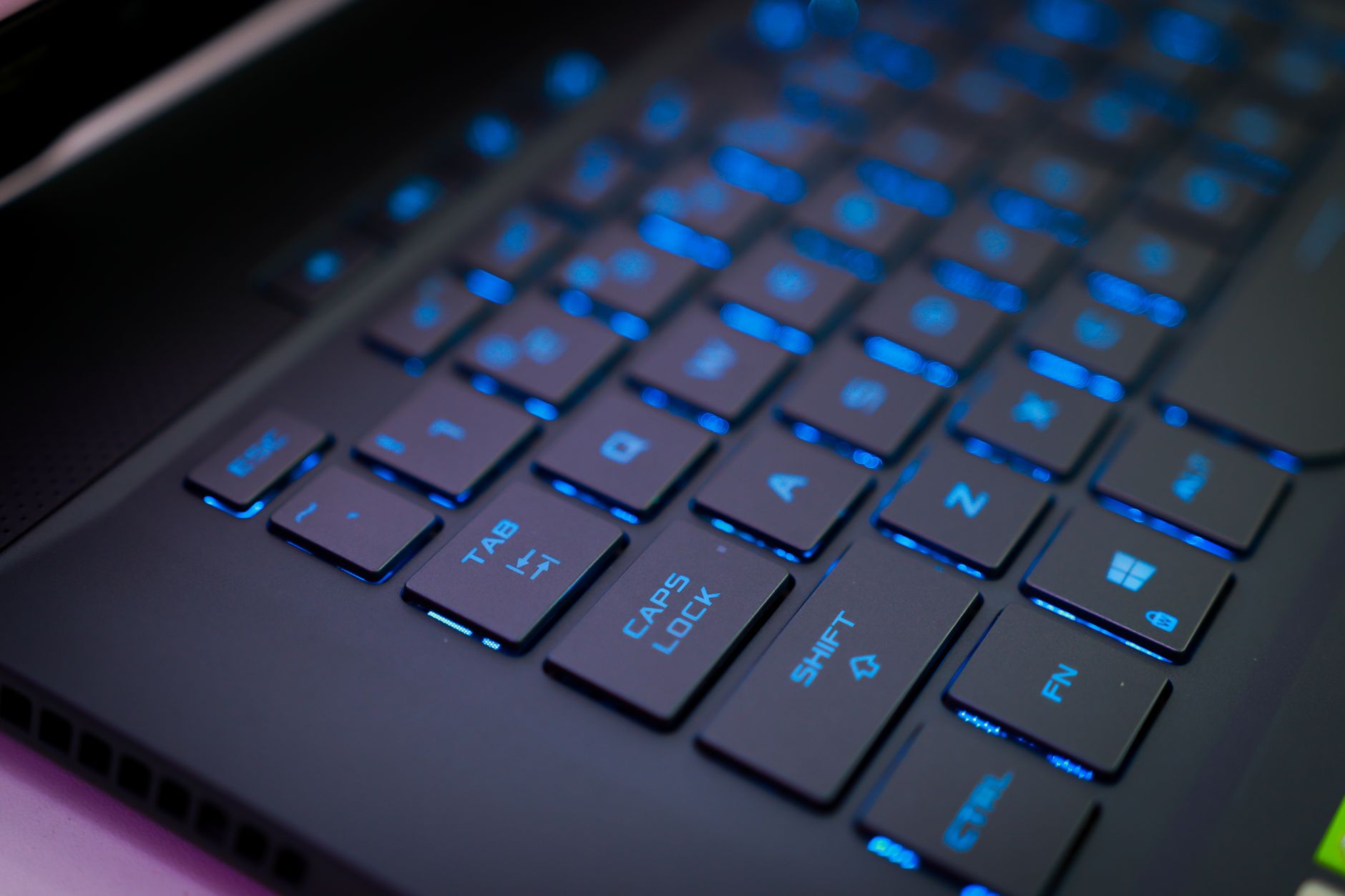 asus rog keyboard not working - Close-up of an illuminated mechanical keyboard with blue backlit keys, perfect for tech enthusiasts.