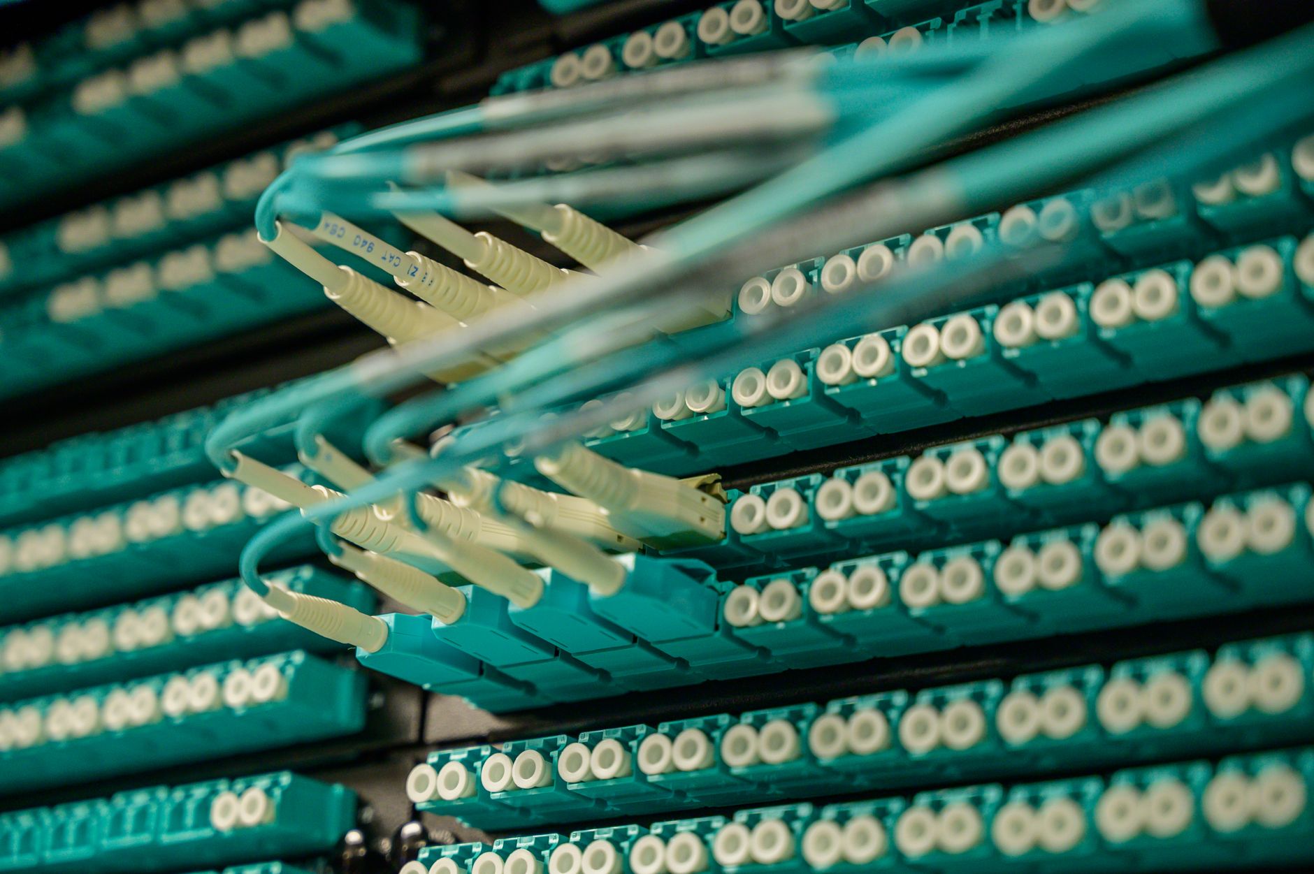 at&t fiber optic cable repair - Detailed view of fiber optic cables connected to a server rack, showcasing modern technology.