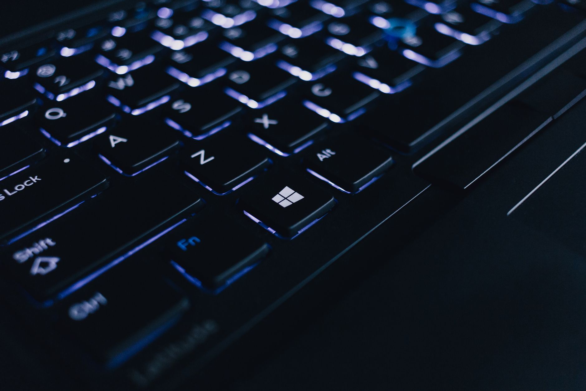 computer is connected but no internet - Detailed view of an illuminated laptop keyboard showing individual keys and backlight effect.