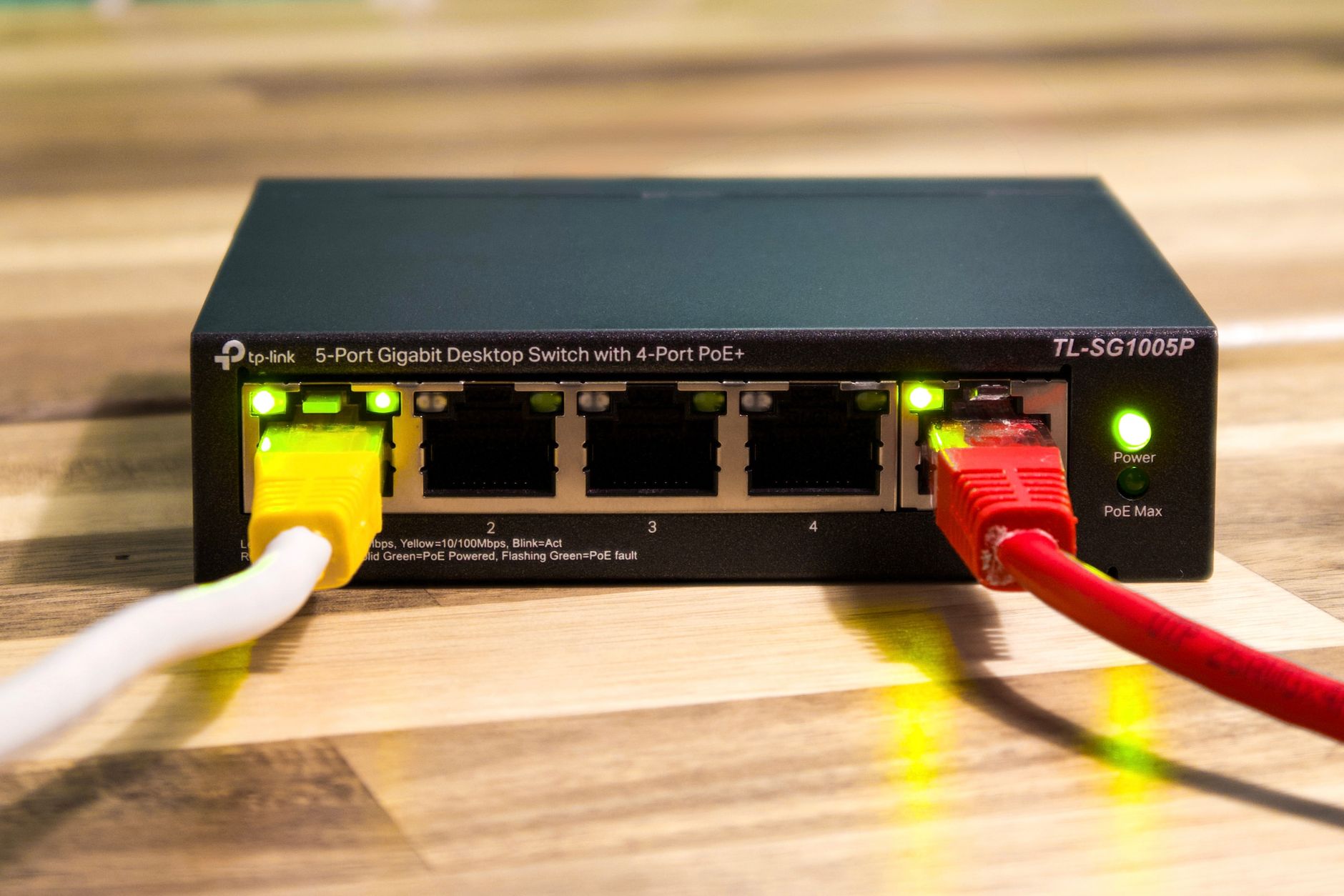 connected to internet but no wifi - Close-up of a TP-Link Ethernet switch with yellow, red, and white cables connected.