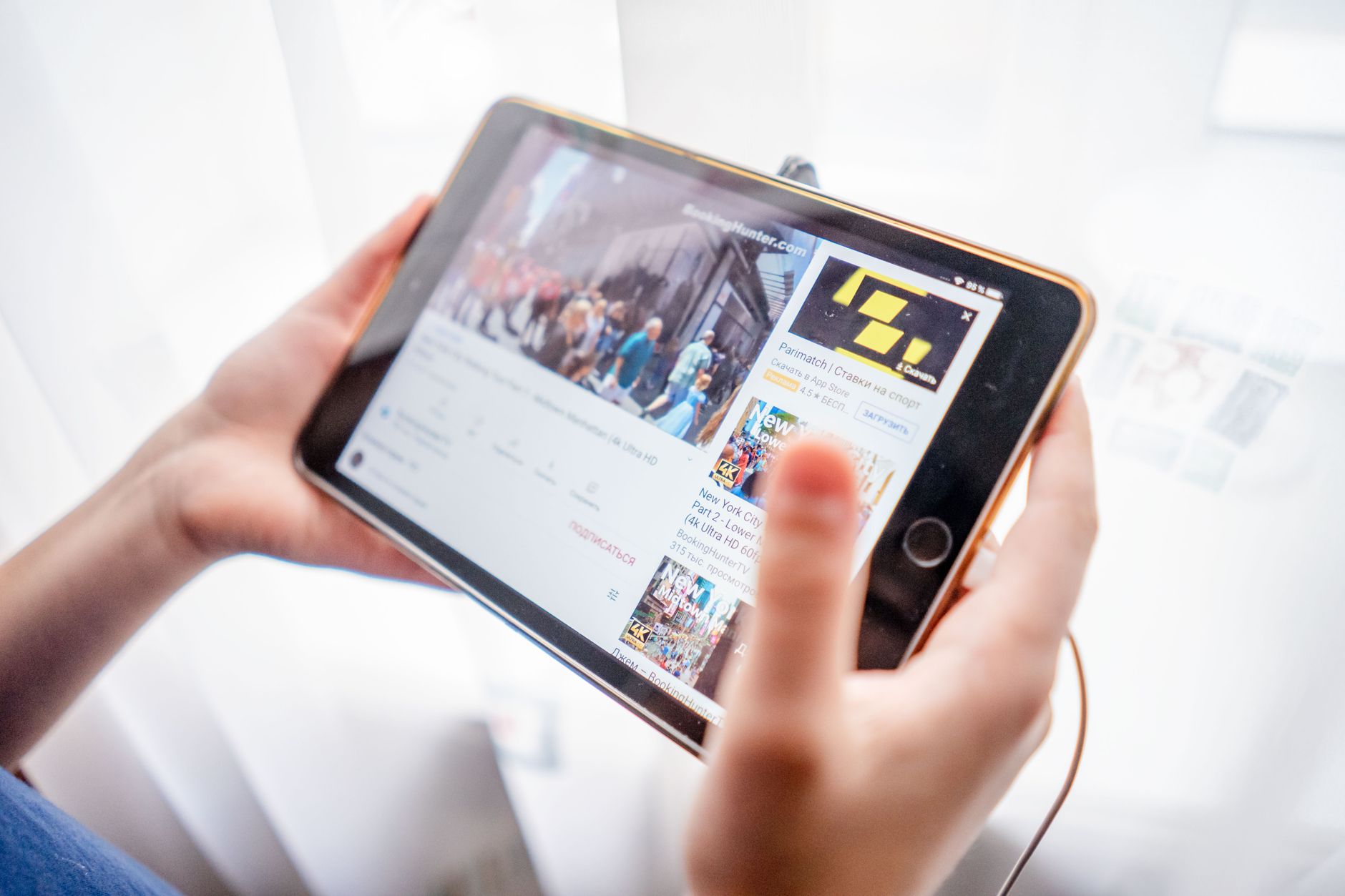 how to fix limited connection in wifi - Close-up of hands holding a tablet device browsing online content indoors.