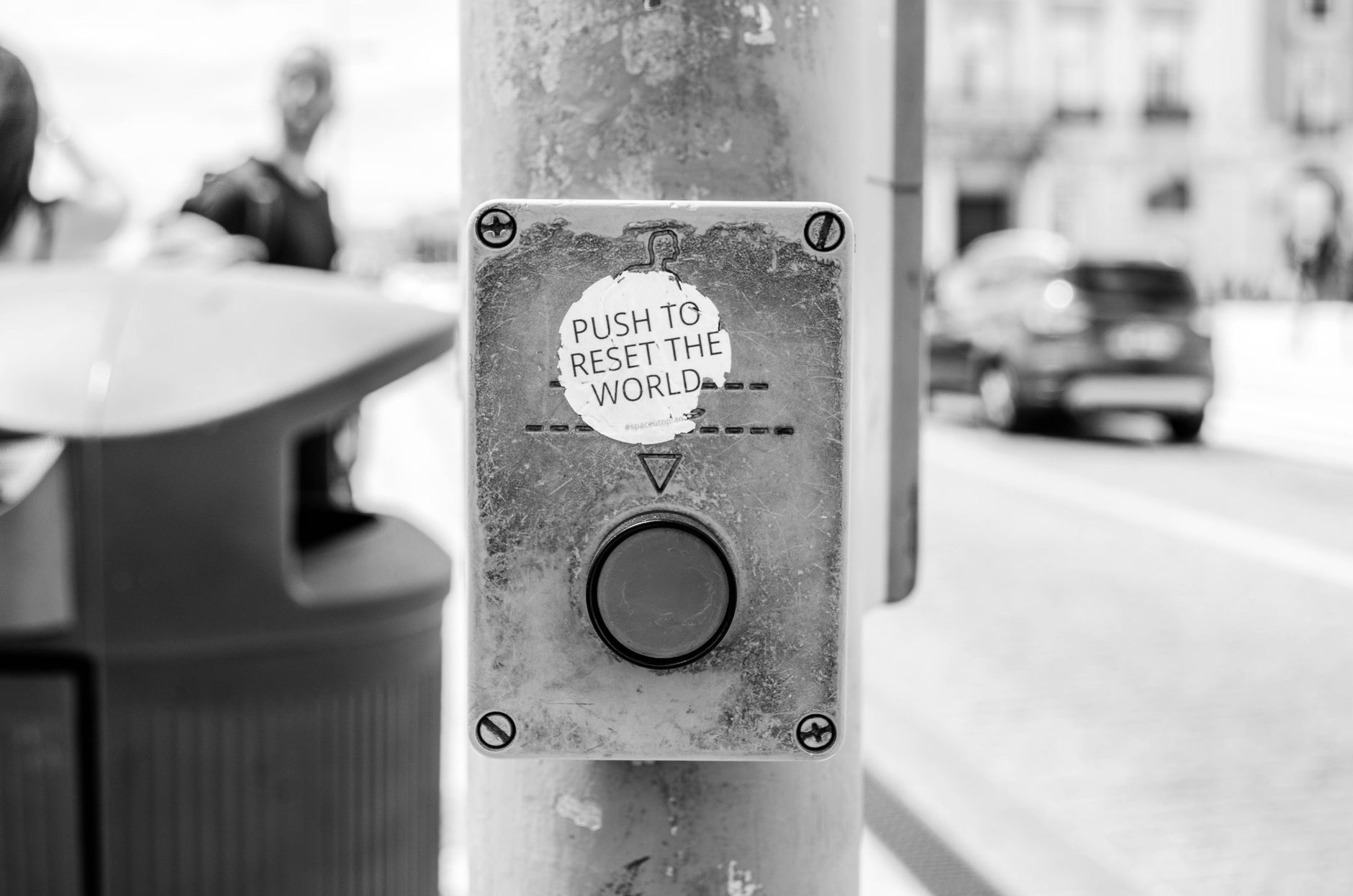 how to reset network settings in windows 10 - Grayscale photo of a street button labeled 'Push to reset the world', Lisbon urban scene.