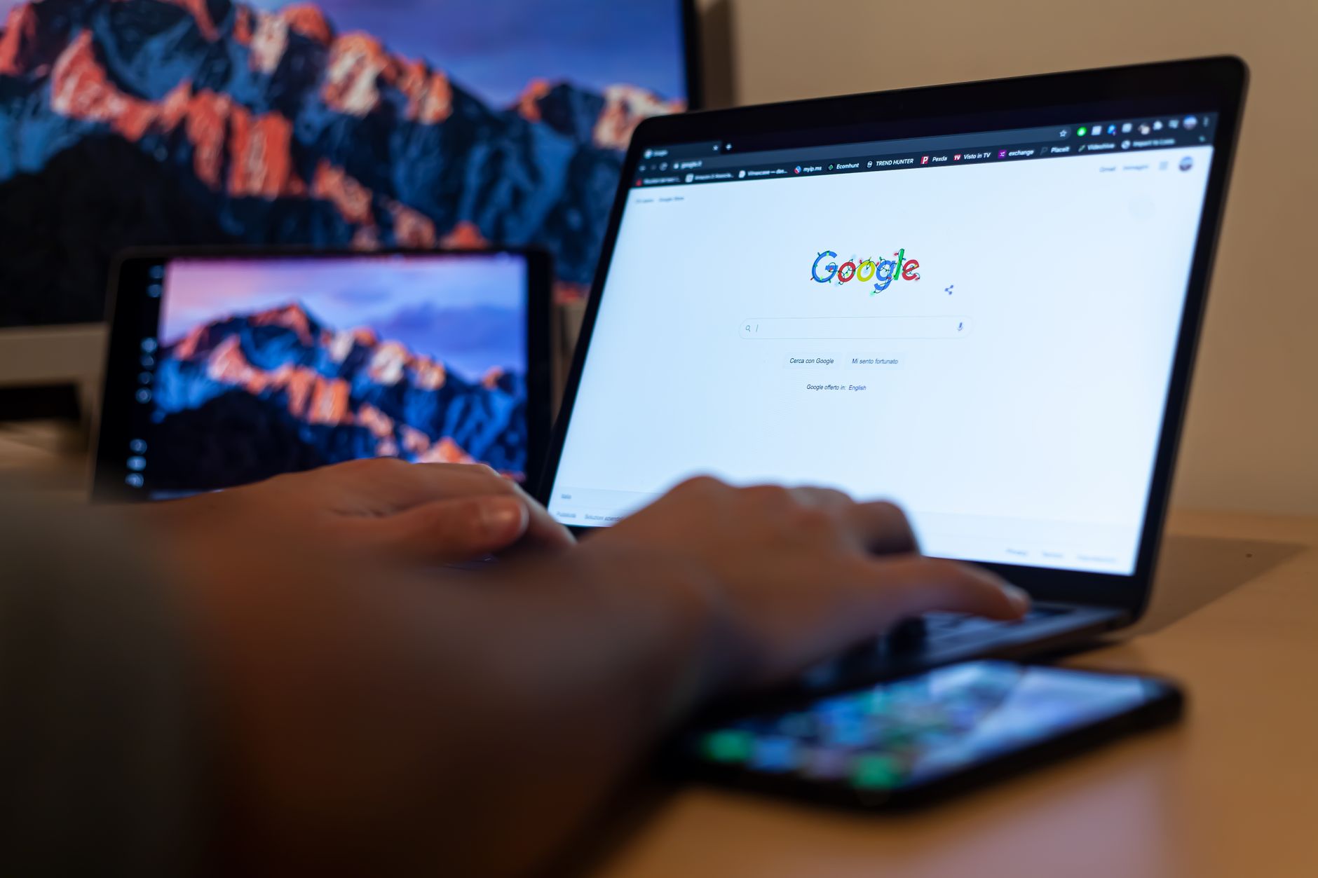 internet no internet access - Hands typing on a laptop with Google on screen, in a remote work setup in Milan, Italy.