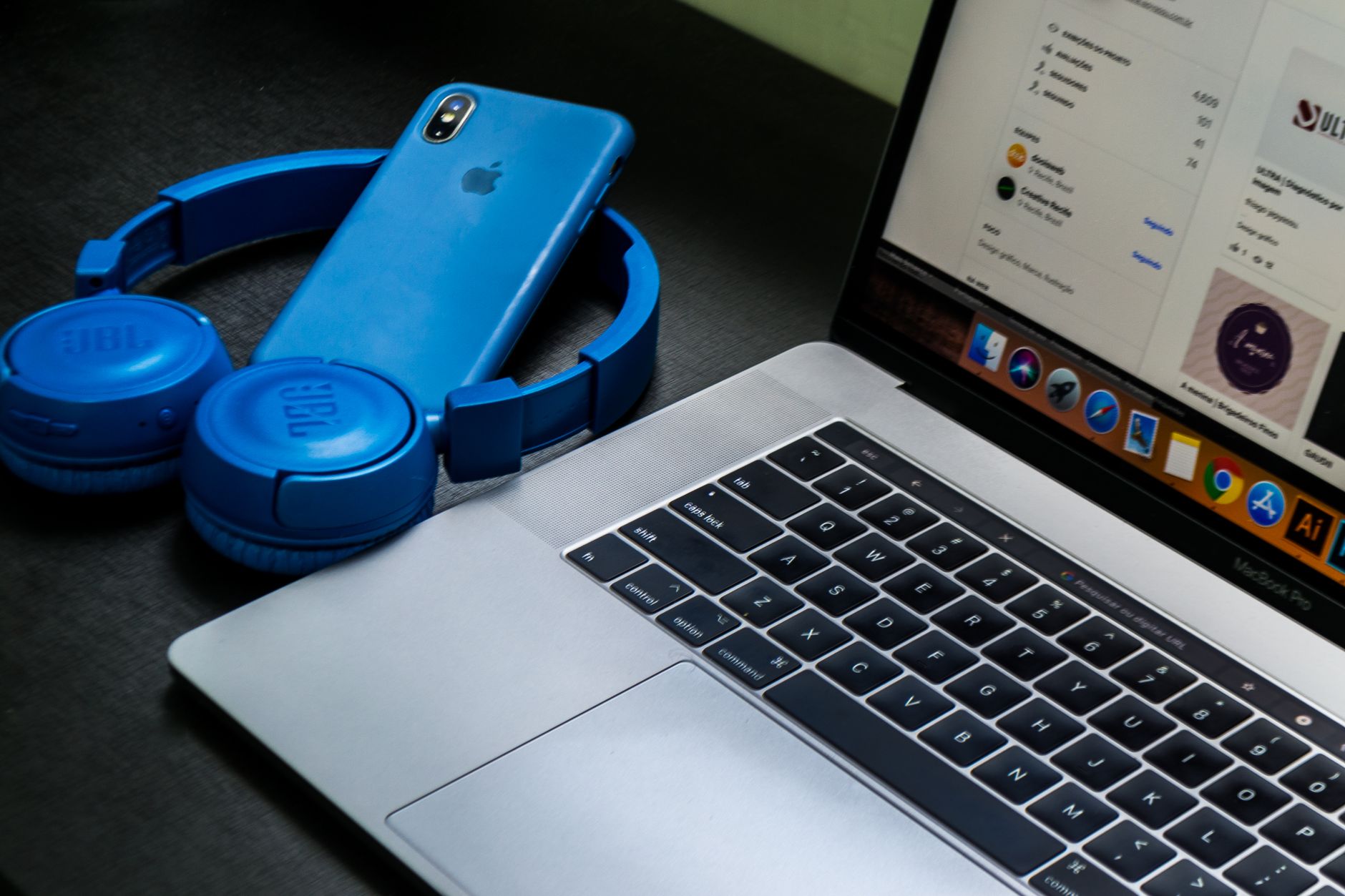 laptop connected but no internet - A sleek office setup featuring a laptop, blue headphones, and a smartphone, exemplifying modern technology.