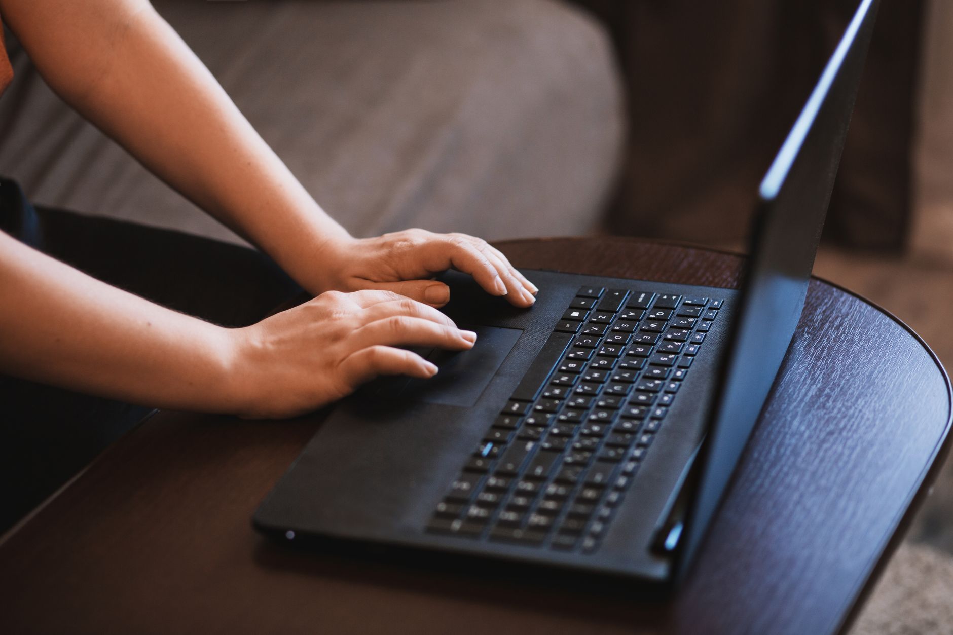 laptop connected but no internet - A close-up image of hands typing on a laptop, emphasizing technology and work.
