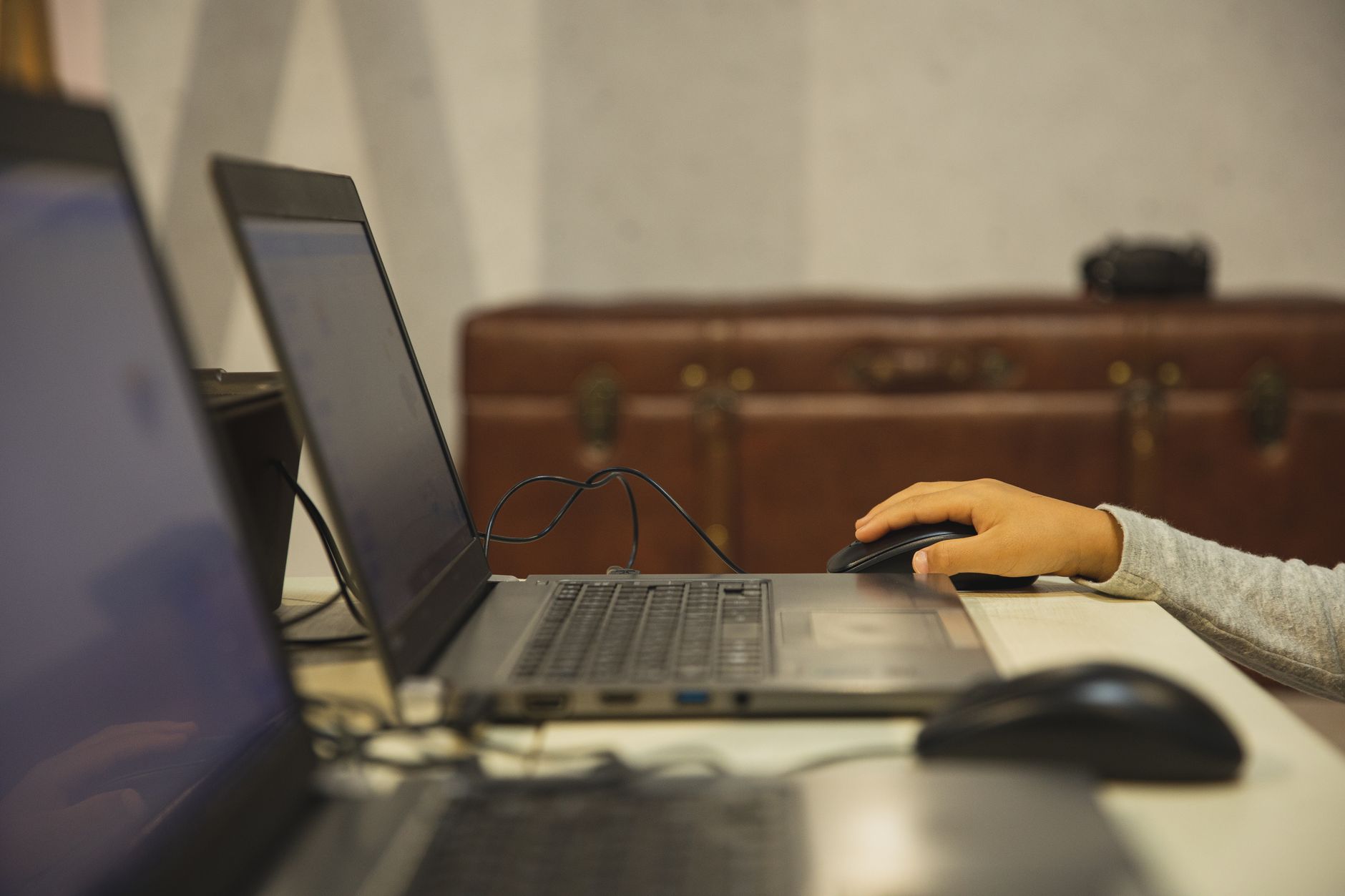 pc says connected but no internet - Crop anonymous schoolkid against open netbook with information on screen studying at table in classroom