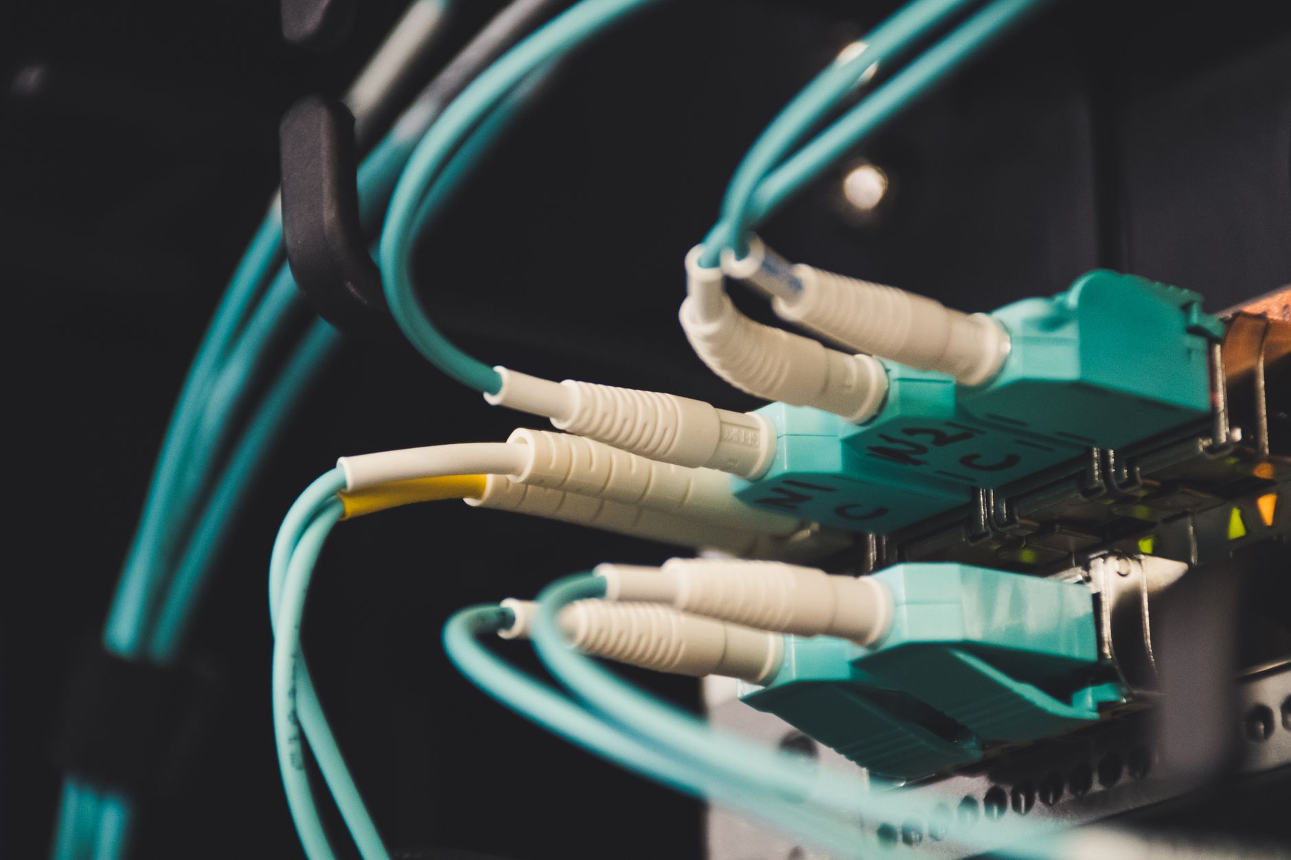 reset lan adapter windows 10 - Detailed view of fiber optic cables and ports in a server room, showcasing connectivity.