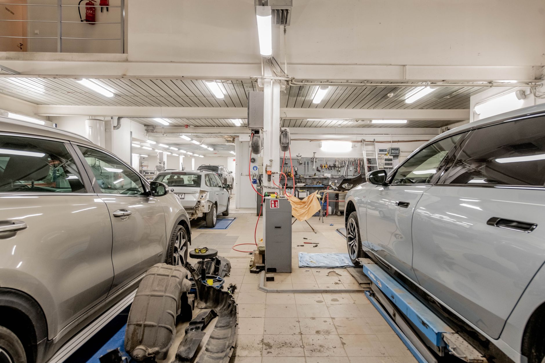 route 401 auto repair - Interior of an automotive repair shop with cars undergoing maintenance and servicing.
