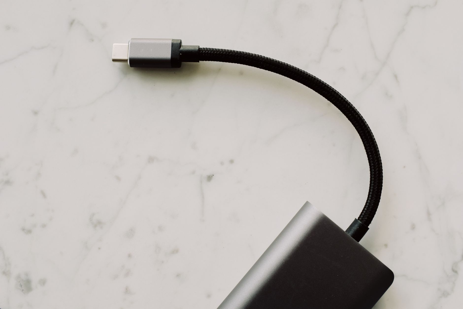 usb wifi adapter not working - High-quality USB-C cable with connector displayed on elegant marble background for tech enthusiasts.