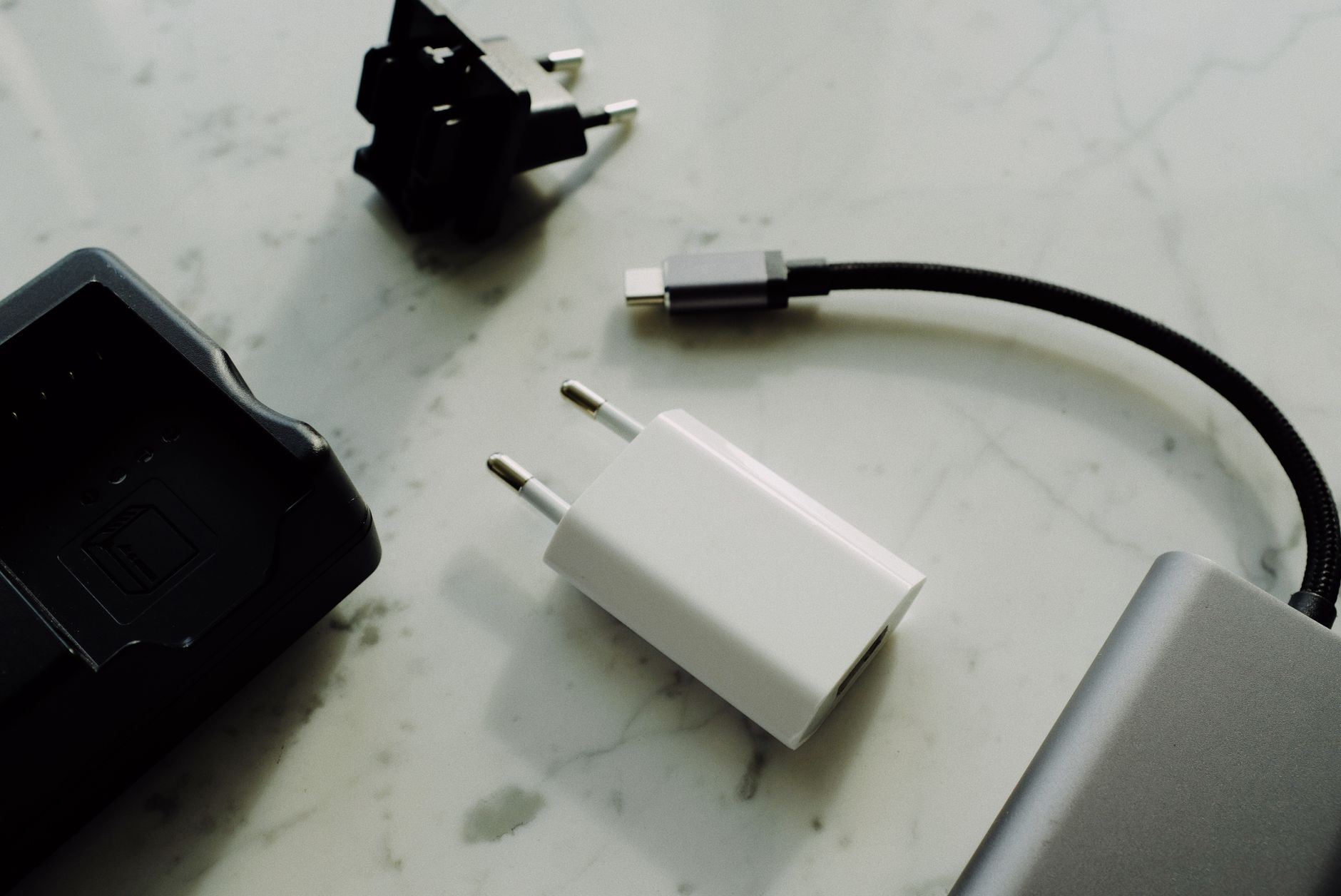 usb wifi adapter not working - Set of various modern charging unit with adapter and small external battery pack with short cable placed on white marble table