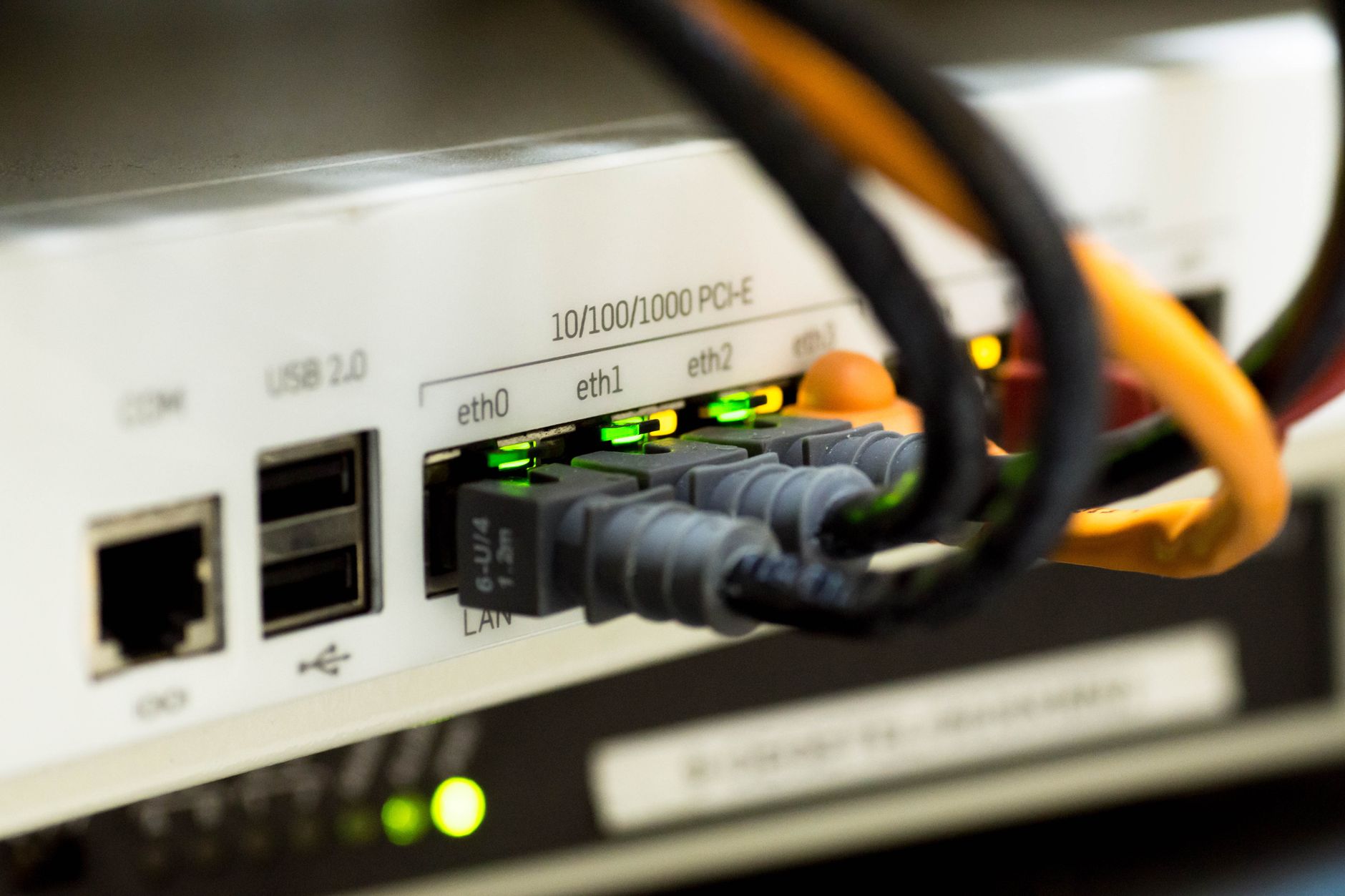 what is a networking reset - Detailed close-up of ethernet cables and network connections on a router, showcasing modern technology.