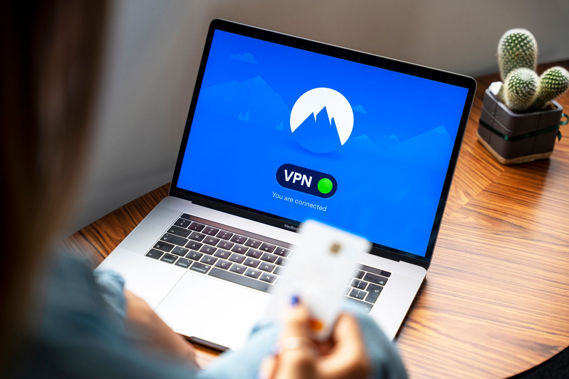 why computer won't connect to wifi - A person using a VPN on a laptop, symbolizing secure internet browsing in a modern indoor setting.