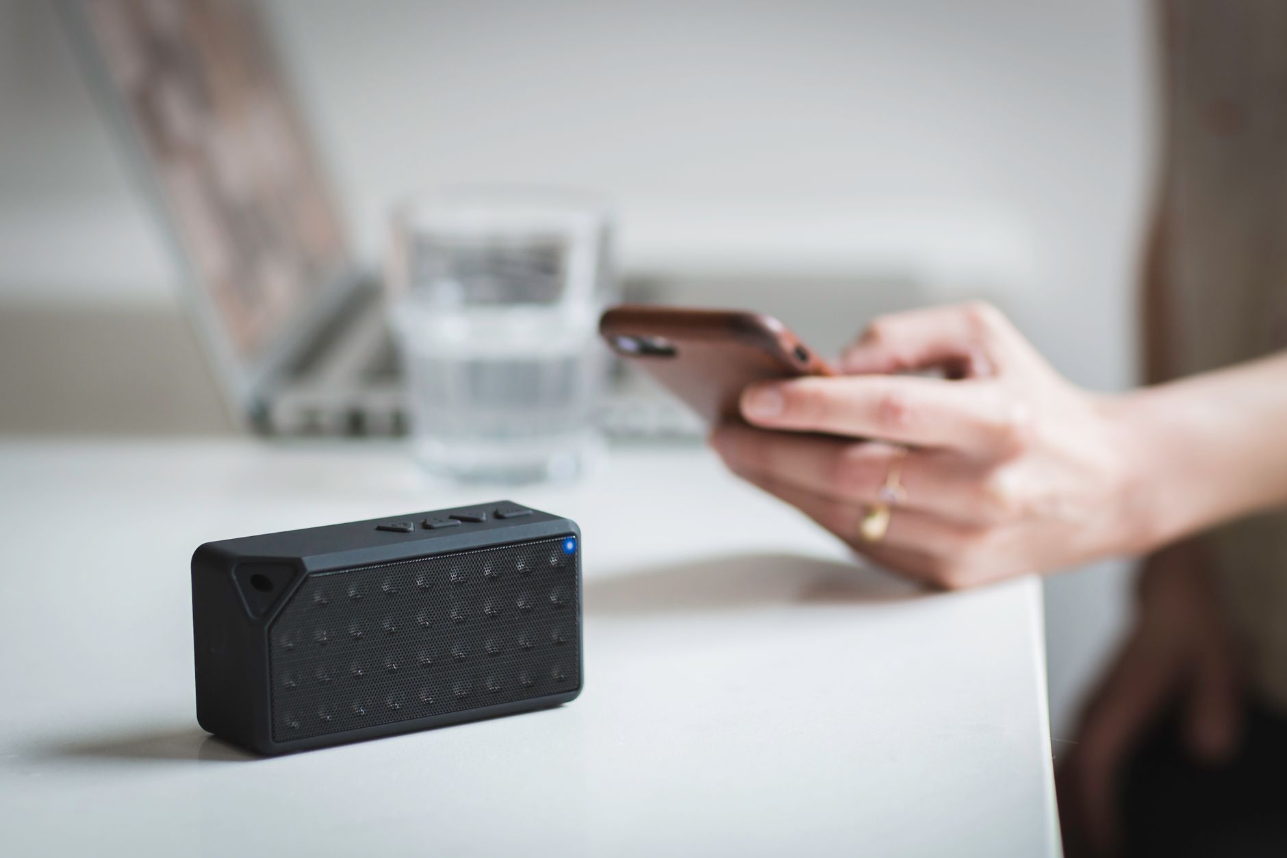 why won't my devices connect to wifi - Person connecting a smartphone to a wireless speaker indoors, foreground focus.