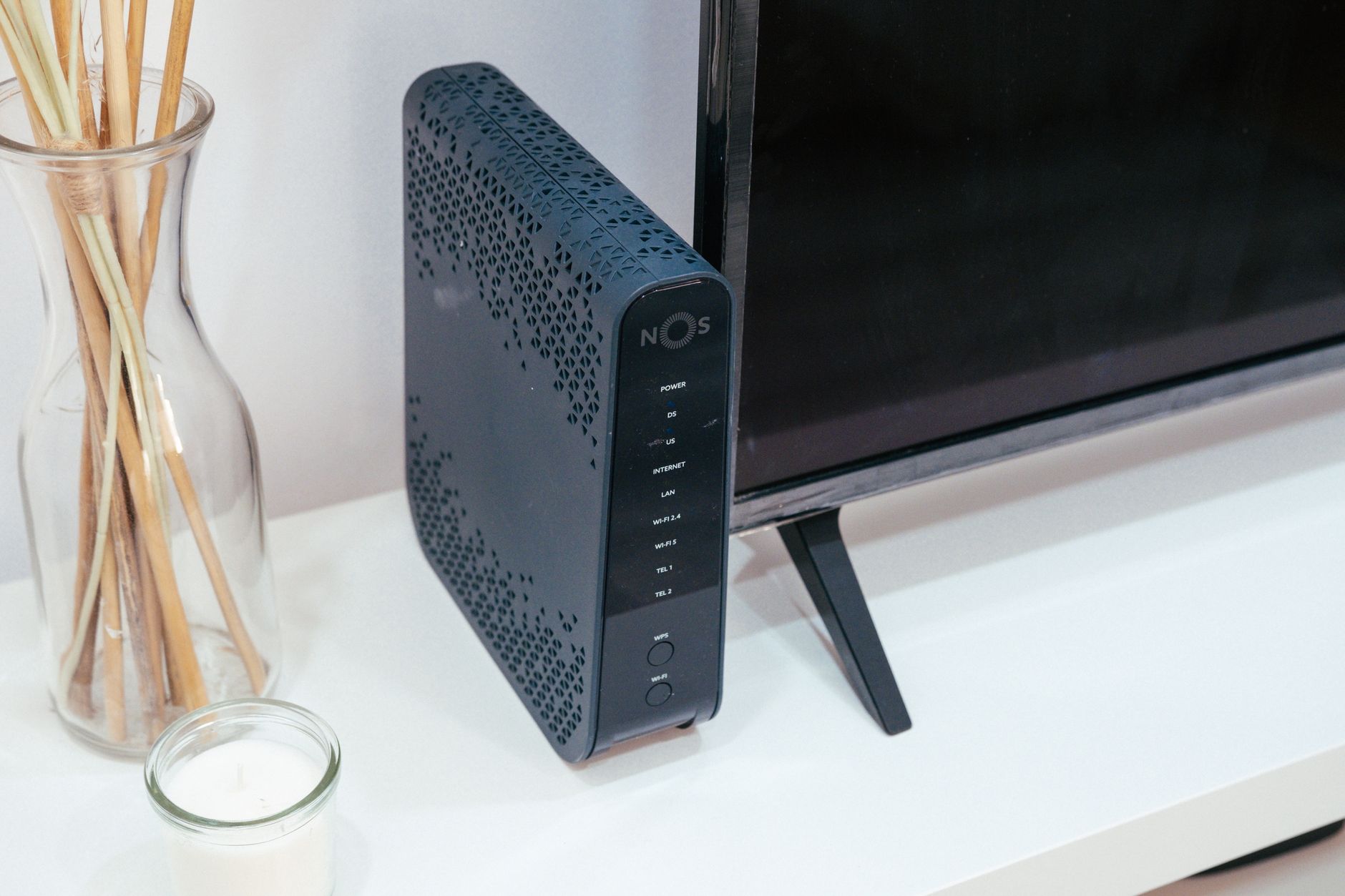 why won't my pc connect to the wifi - A sleek home technology setup featuring a router, glass decoration, and television.