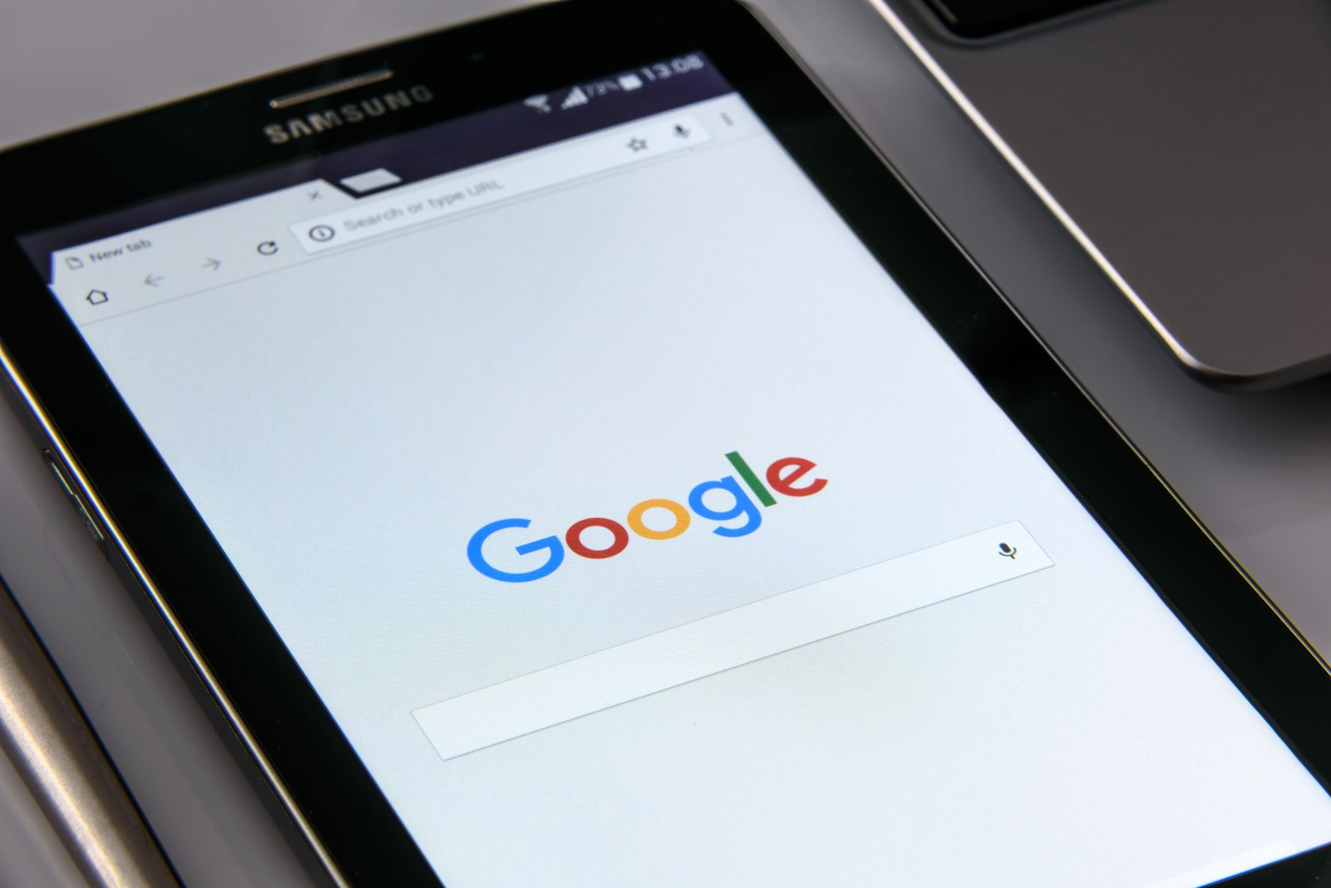 wifi connected no internet windows 11 - Close-up of a tablet displaying Google's search screen, emphasizing technology and internet browsing.