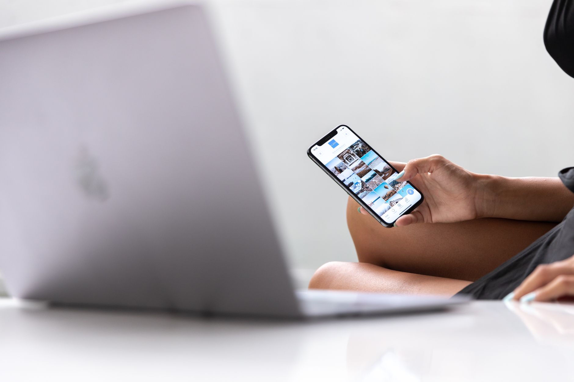 wifi is working on phone but not on laptop - A woman multitasks using a smartphone and laptop, symbolizing modern digital nomad lifestyle in Bali.