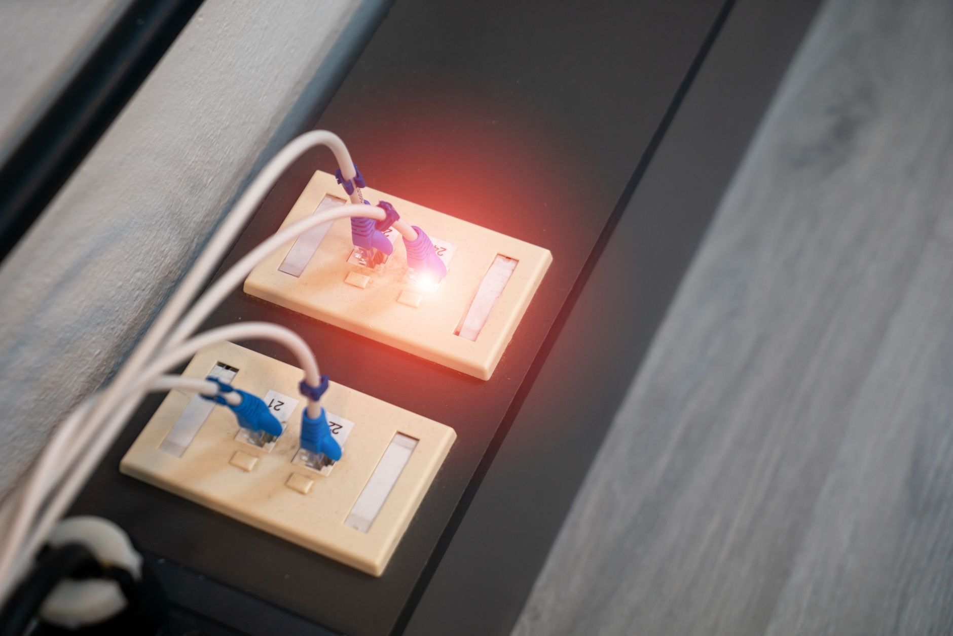 wifire won't connect - Close-up view of Ethernet ports with cables and illuminated LED indicator. Modern data connection setup.